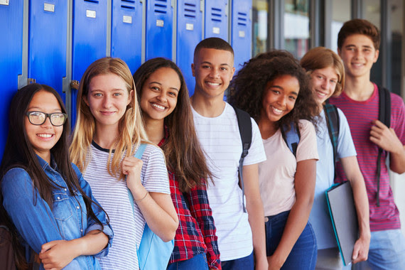 Middle and high school students in front of lockers