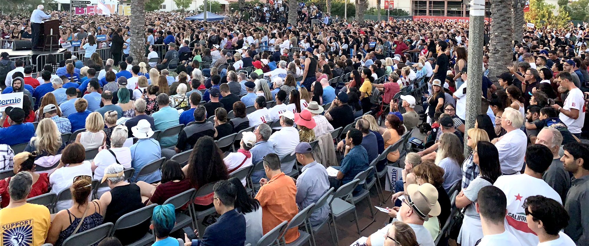 High angle shot of large crowd listening to Bernie speak at Long Beach rally