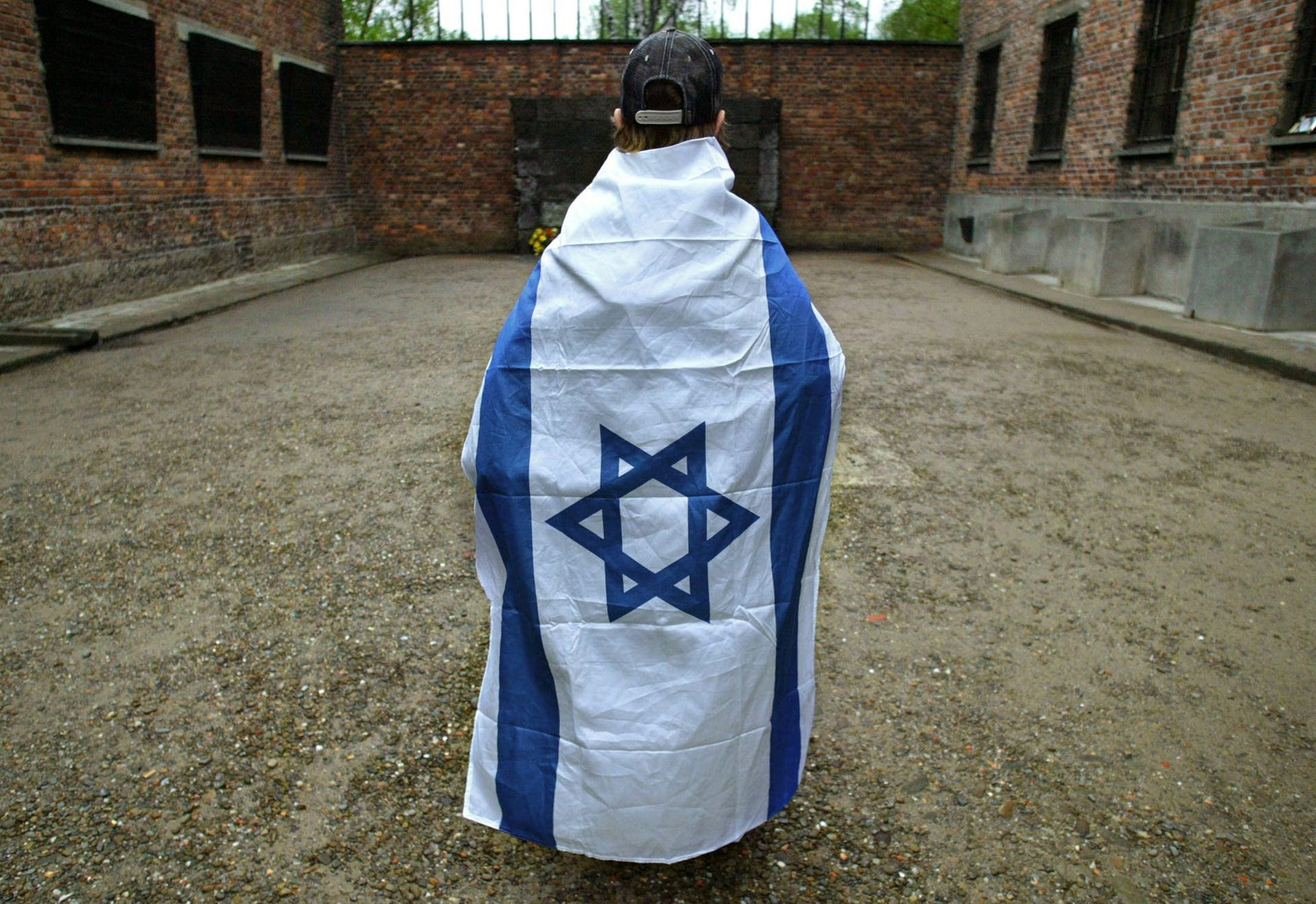 A boy looks at the death wall in the former Nazi death camp of Auschwitz before the 'March of the Living' in Oswiecim, Poland, May 5, 2005.