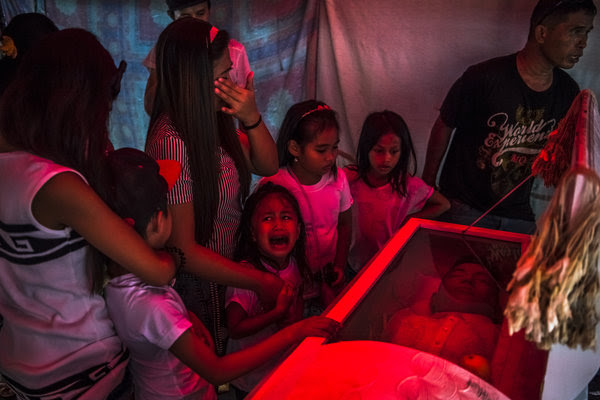 Jimji, 6, cried out in anguish, saying “Papa” as workers moved the body of her father, Jimboy Bolasa, 25, for burial.