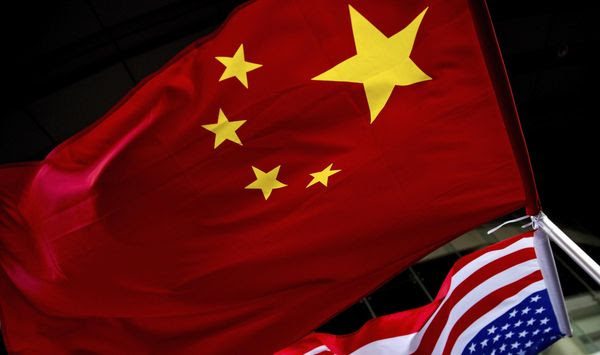 U.S. and Chinese national flags are hung outside a hotel during the U.S. Presidential election event, organized by the U.S. Embassy in Beijing. (AP Photo/Andy Wong) ** FILE **