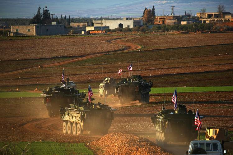 A convoy of U.S. armored vehicles drove on the outskirts of Manbij, Syria, in early March.