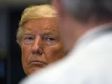 President Donald Trump listens during a tour of the Viral Pathogenesis Laboratory at the National Institutes of Health, Tuesday, March 3, 2020, in Bethesda, Md. (AP Photo/Evan Vucci)