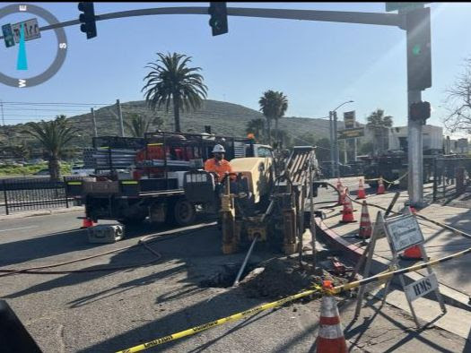 Crews install traffic signal wiring at Camino de la Plaza.