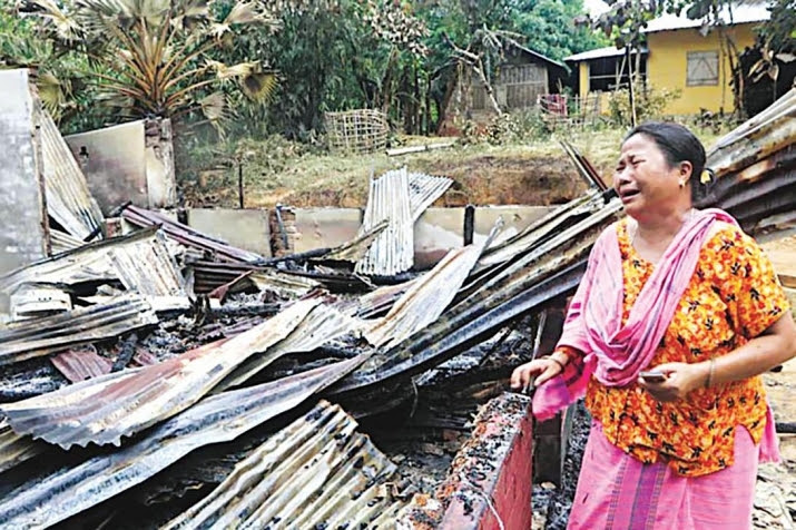 An indigenous woman in tears in front of the house in which her 70-year-old mother burned to death. Photo by Prabir Das. From thedailystar.net