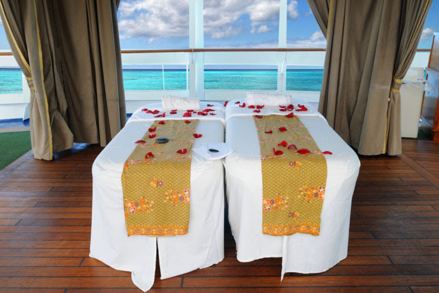 Massage Beds on Cruise (Photo: R. Gino Santa Maria/ Shutterstock) Massage beds with beautiful tropical beach in background