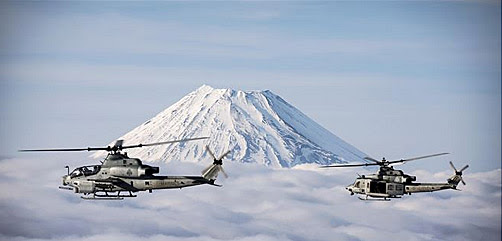 Two Marine Corps helicopters, an AH-1Z Viper and UH-1Y Venom, fly past Mount Fuji, Shizuoka, Japan, March 12, 2017 - ALLOW IMAGES