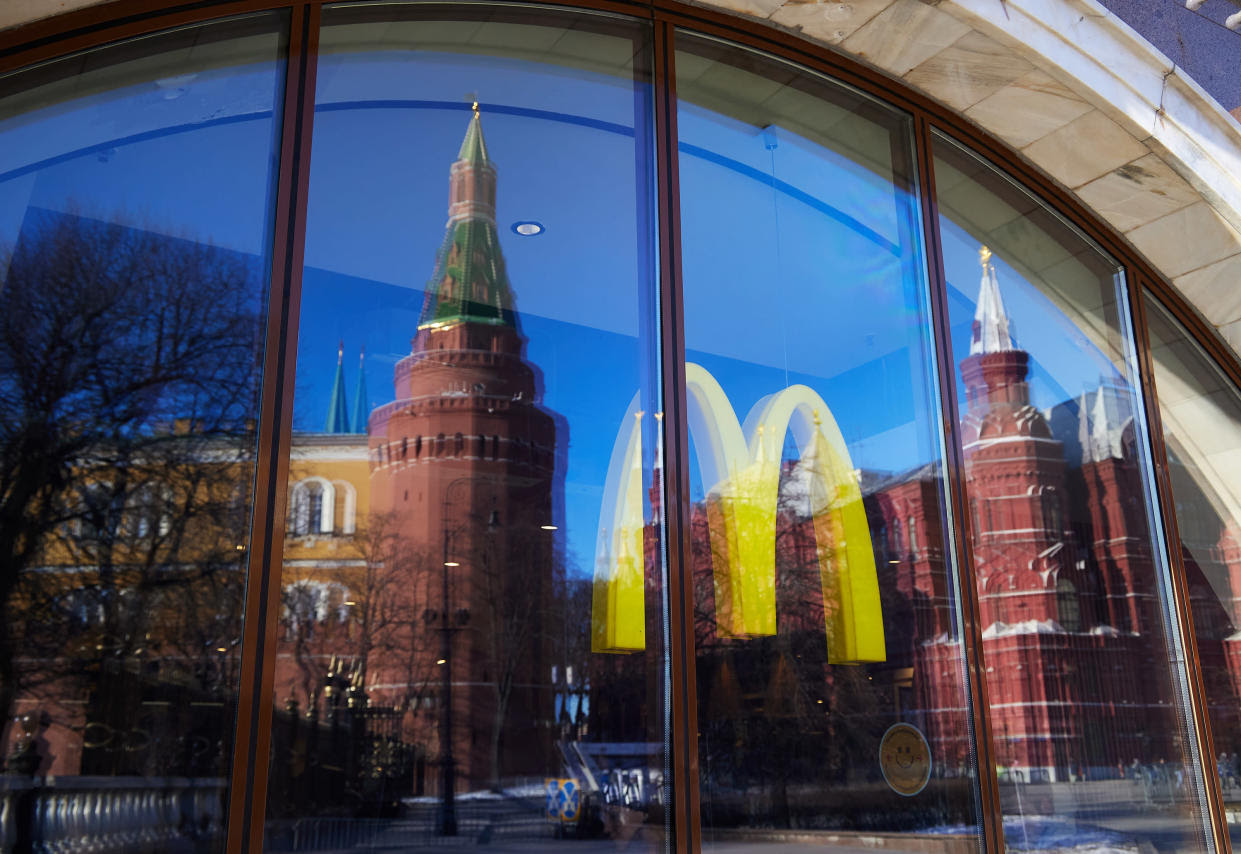 The Kremlin tower in Moscow is reflected in a McDonald&#39;s window showing the company&#39;s iconic golden arches.