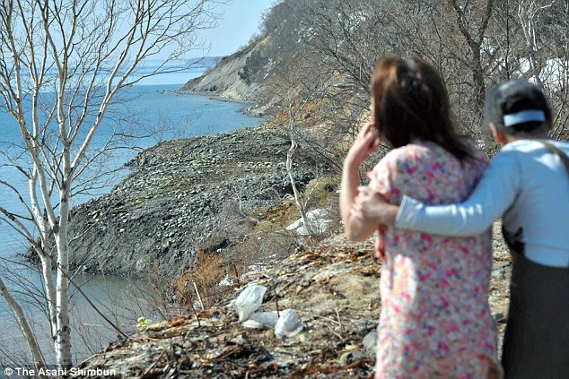 New view: Local residents from Rausu, Hokkaido, take a look at the newly emerged coastline