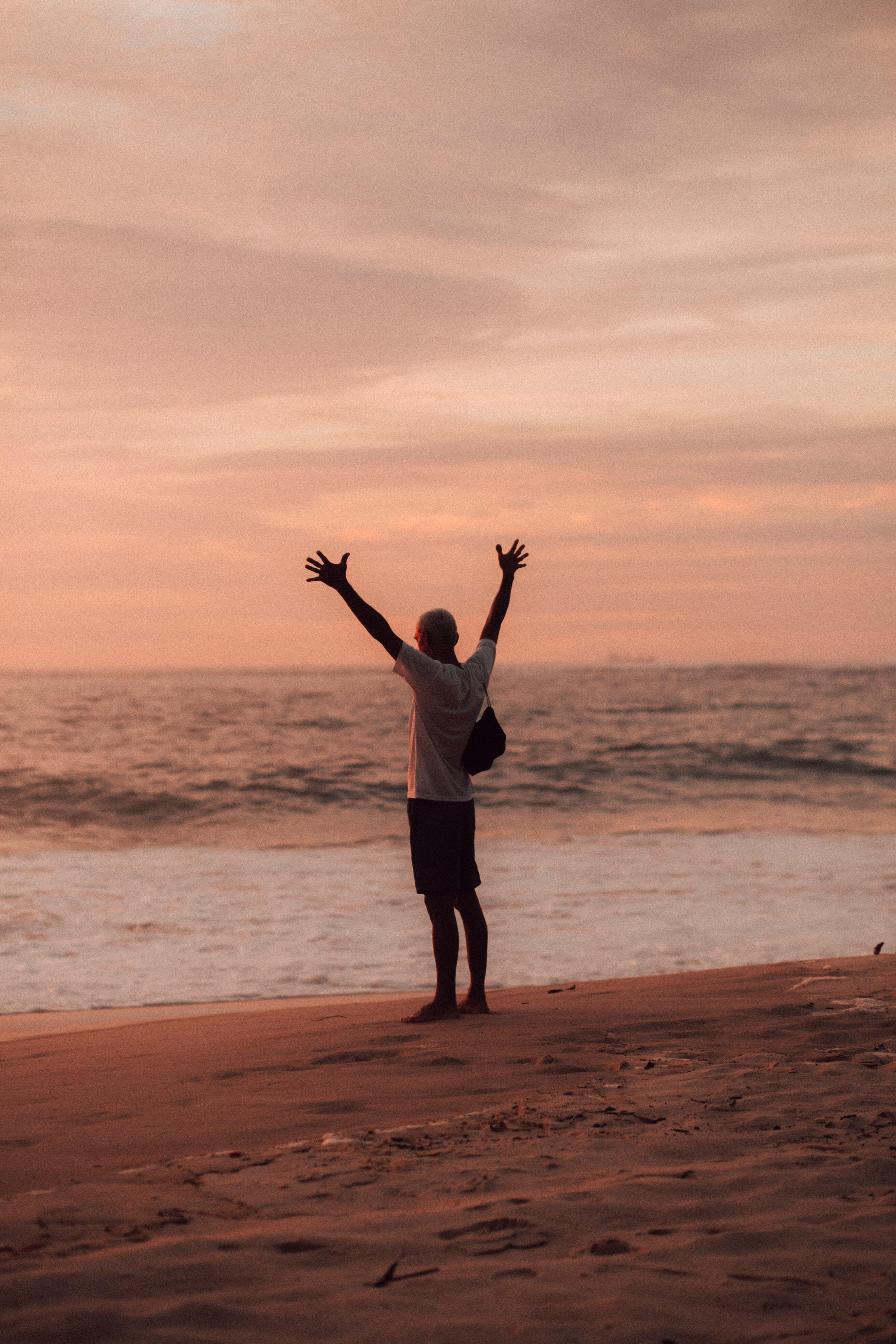 man on beach at sunset