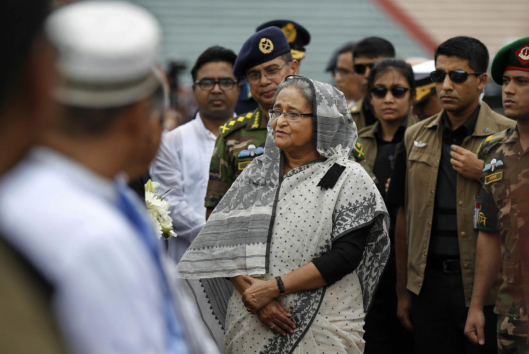 Prime Minister Sheikh Hasina speaks with family members at a memorial service on July 4, 2016, for victims of the Holey Artisan attack three days before. (Photo by AP)