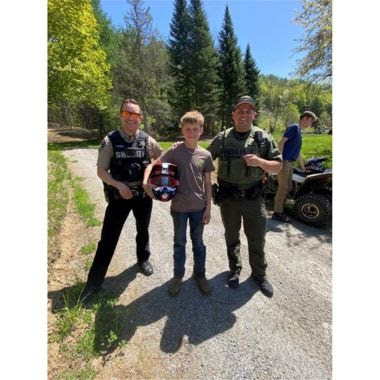 Officer, ECO, and teenager pose for picture after being found