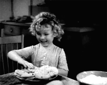 Shirley Temple delighted to take a cookie