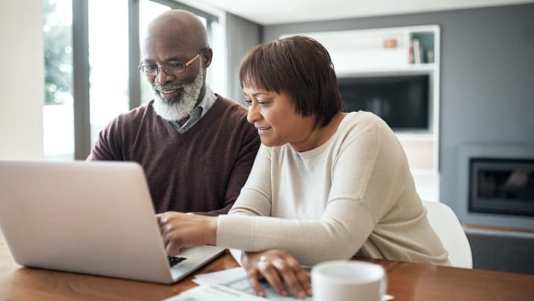 Couple looking over a computer together