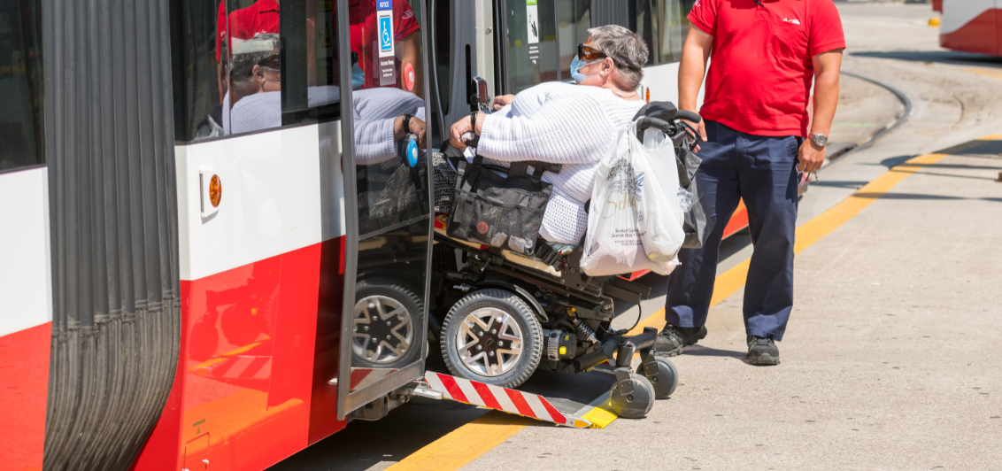 A TTC customer uses the streetcar ramp to enter the vehicle
