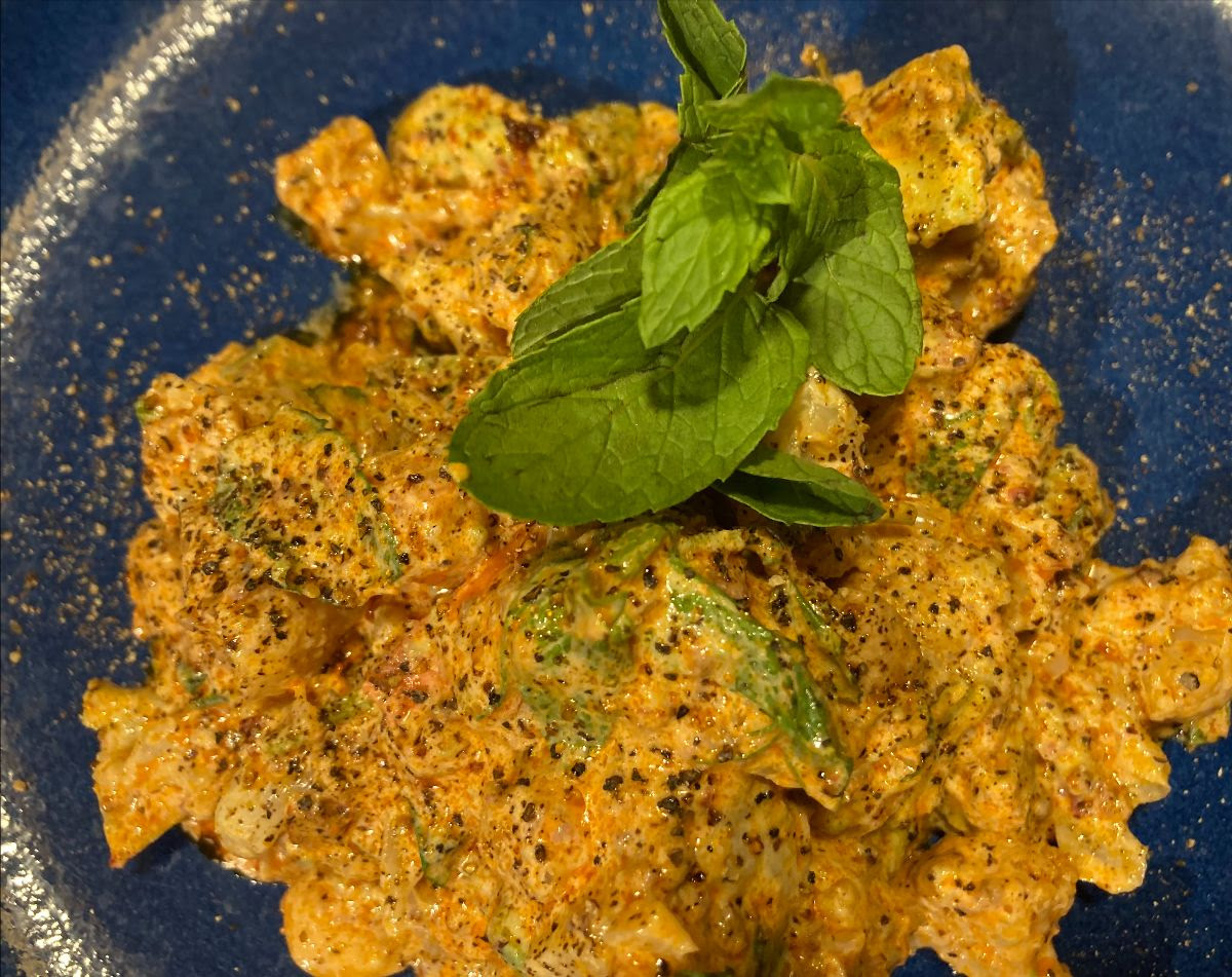 a salad of cauliflower and harissa with basil leaves