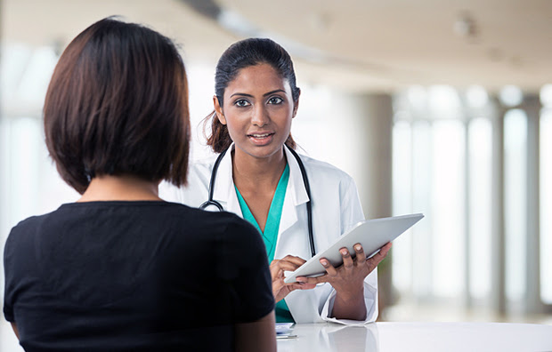 A doctor speaking with a female patient.