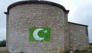 France: Pakistani flag painted on wall of 11th-century chapel