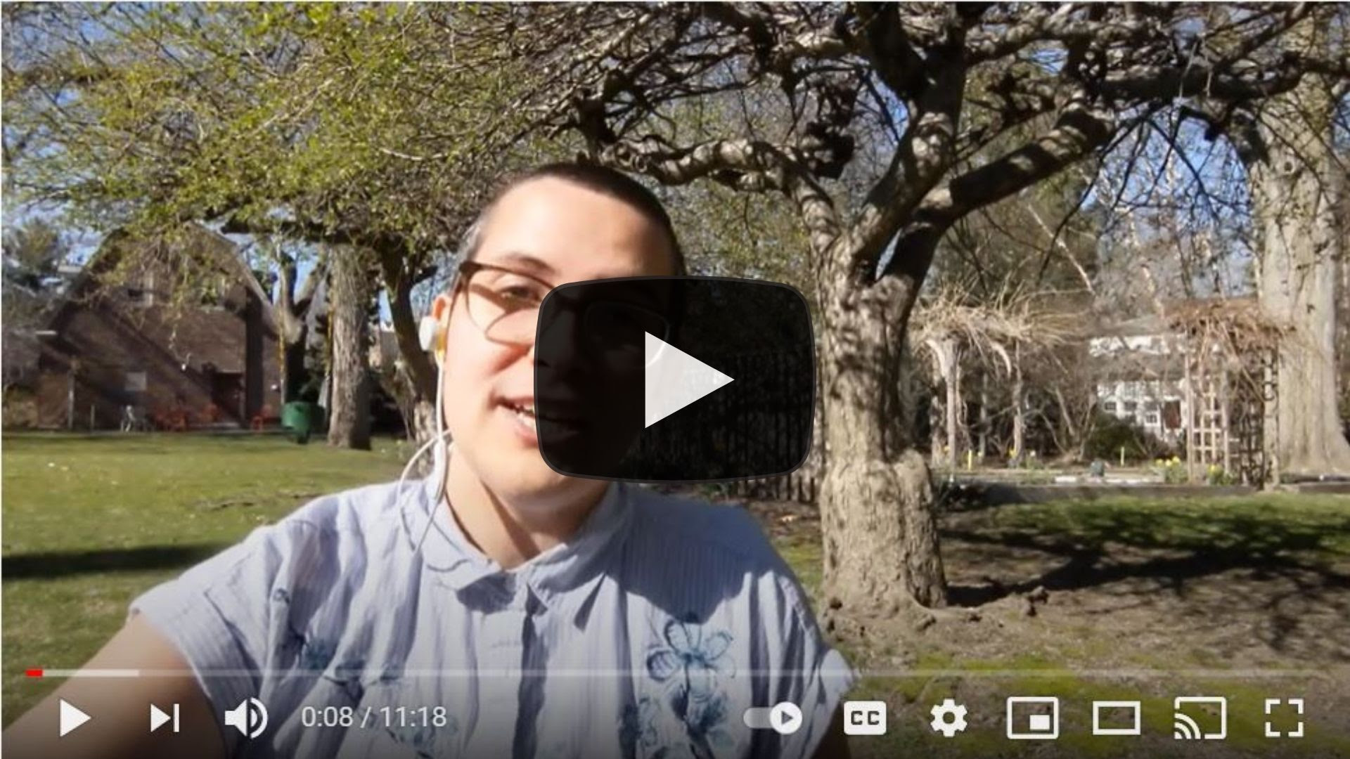 Still image from a video in which Lóre Stevens delivers a sermon in a garden