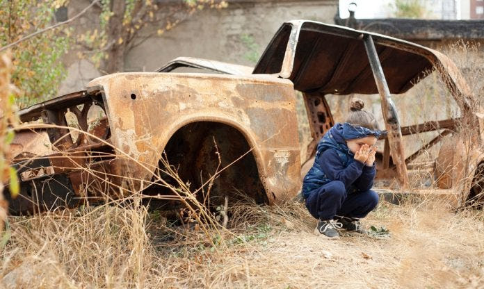 A,Little,Girl,Is,Crying,Near,The,Burnt,Car.,War