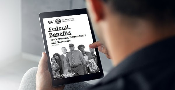 Veteran reading the 2021 Federal Benefits Handbook for Veterans, Dependents and Survivors