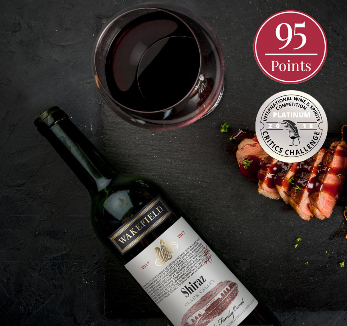 Bottle and glass of Heritage Shiraz Clare Valley by Wakefield Wines 2017  "95 Points" and "Critics Challenge" seals