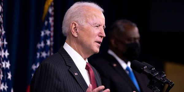 U.S. President Joe Biden stands at a podium.