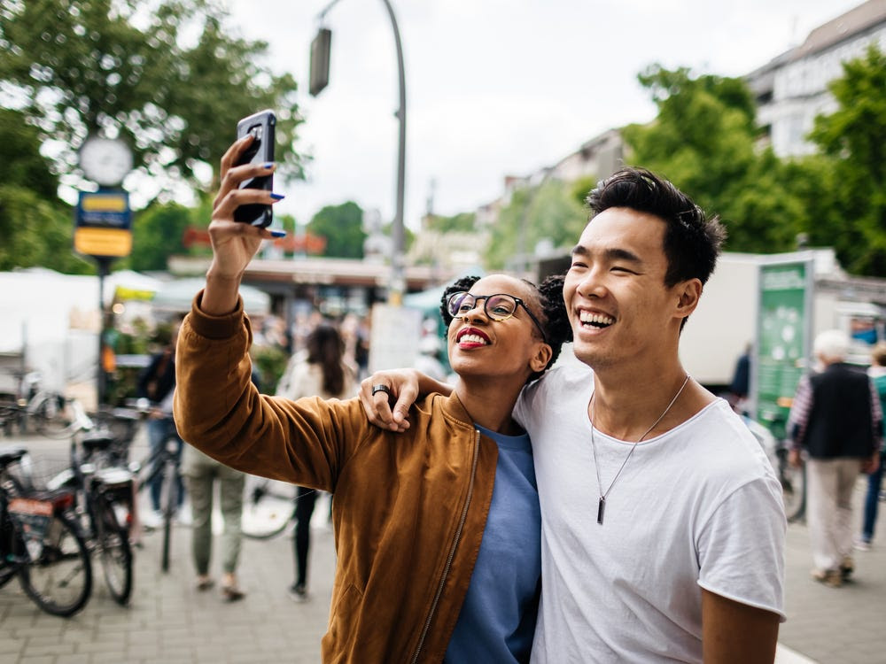 A smiling couple takes a selfie.