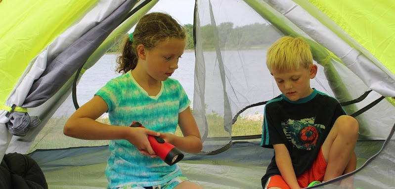 A boy and girl in a tent.