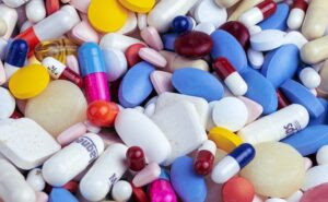 pile of a variety of pills and medications in various colors