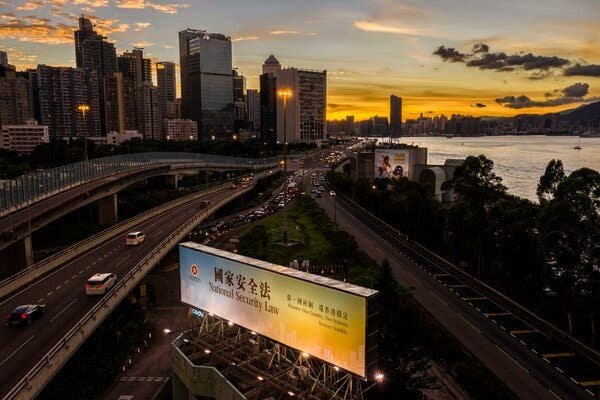 A billboard promoting China’s national security law in Hong Kong in June.Credit...Lam Yik Fei for The New York Times