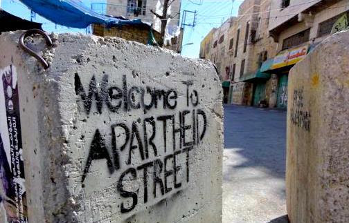 stencil graffiti says welcome to apartheid street