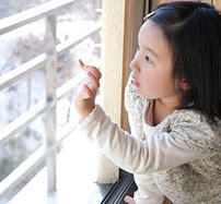 Child writing on a window