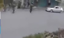 Arab woman driver driving on empty street and in the path of Israeli soldiers who dodged her at the last second.