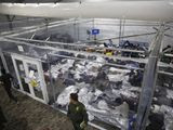 In this March 30, 2021, photo, minors are shown inside a pod at the Donna Department of Homeland Security holding facility, the main detention center for unaccompanied children in the Rio Grande Valley run by U.S. Customs and Border Protection (CBP), in Donna, Texas. A federal volunteer at the Biden administration&#39;s largest shelter for unaccompanied immigrant children says paramedics were called regularly during her the two weeks she worked there. She said panic attacks would occur often after some of the children were taken away to be reunited with their families, dashing the hopes of those left behind. The conditions described by the volunteer highlight the stress of children who cross the U.S.-Mexico border alone and now find themselves held at unlicensed mass-scale facilities waiting to reunite with relatives. (AP Photo/Dario Lopez-Mills, Pool) **FILE**