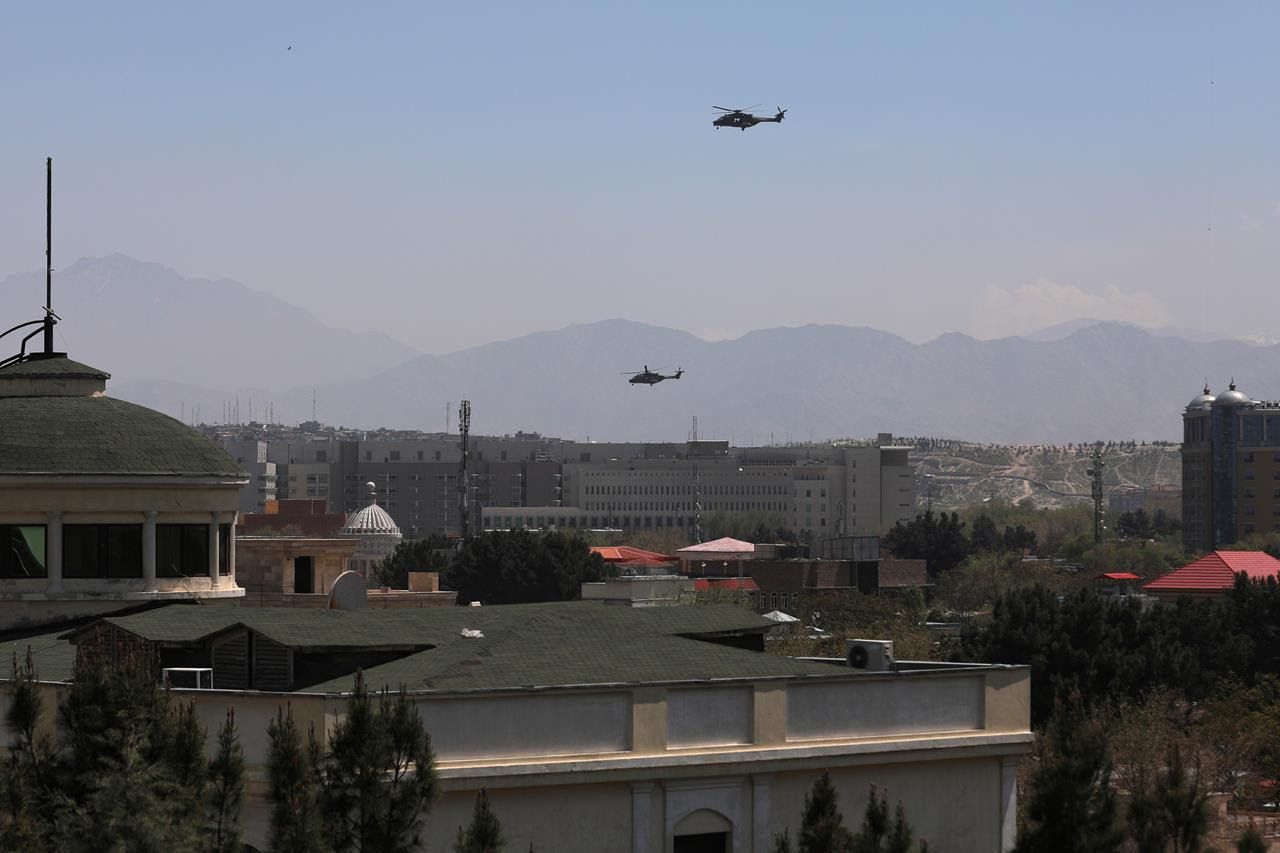 US Black Hawk military helicopters fly over the city of Kabul, Afghanistan, April 19, 2021.