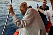Kabbalist Rabbi Kook stands on edge of boat next to IDF ship.