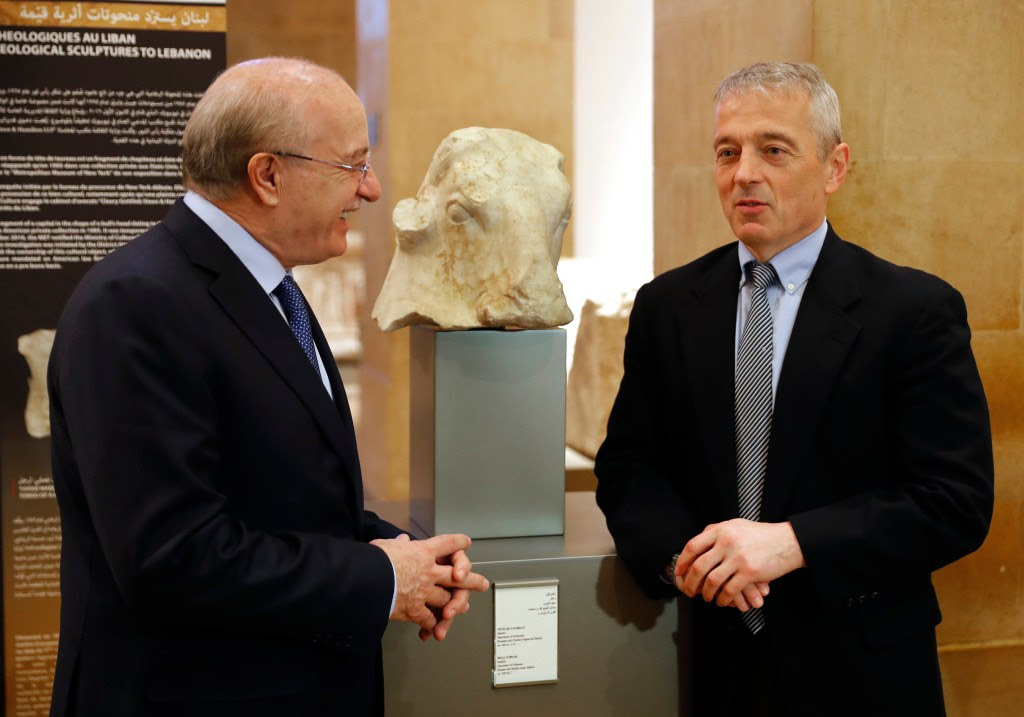 Matthew Bogdanos, right, an assistant District Attorney in Manhattan, speaks with the Lebanese Culture Minister, Ghattas Khoury, left, as they stand next to the ancient sculpture "Bull's Head," center, during a ceremony celebrating the return of three works from the United States, at the Lebanese National museum in Beirut, Lebanon.