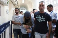 Police dragging into court a resident of Yitzhar in May, 2014