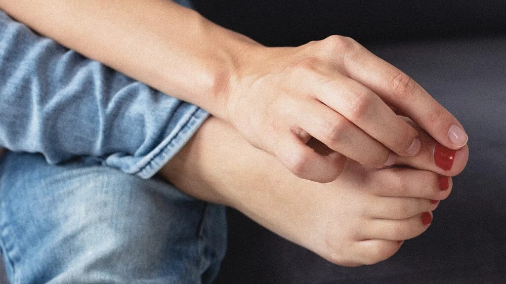 A woman examines her ingrown toenail and wonders "Do ingrown toenails go away?"