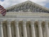 An American flag waves in front of the Supreme Court on Capitol Hill in Washington, Monday, June 29, 2020. (AP Photo/Patrick Semansky)