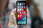FILE - This Sept. 12, 2018, file photo shows an Apple iPhone XR on display at the Steve Jobs Theater after an event to announce new products, in Cupertino, Calif. (AP Photo/Marcio Jose Sanchez, File)