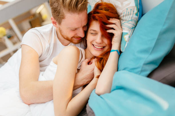 Romantic Couple In Love Lying On Bed And Being Passionate Stock Photo -  Download Image Now - iStock