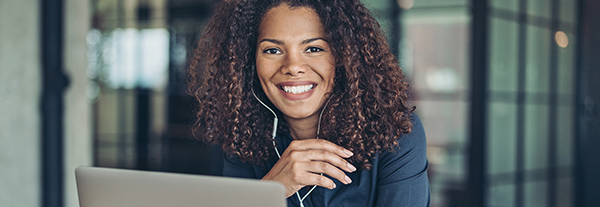 Woman smiling watching webinar