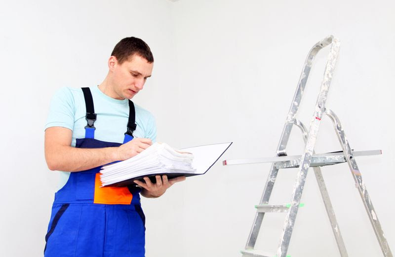 An employee inspects a ladder.