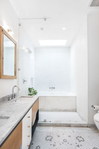 bathroom with skylight and double sink