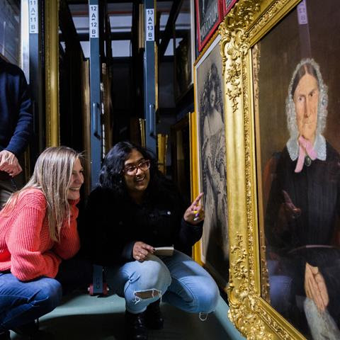Two people looking a painting