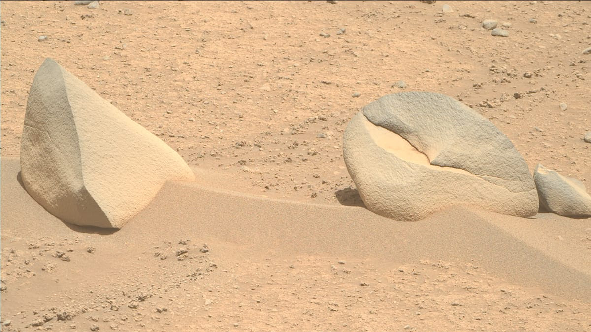 Two Mars rocks with smooth faces lie in the Mars surface dust near one another in this Image of the Week chosen by the public.