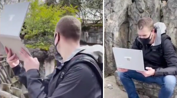 Teacher leads virtual field trip with laptop at zoo