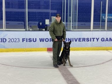 ECO and K9 stand on the ice rink during winter games